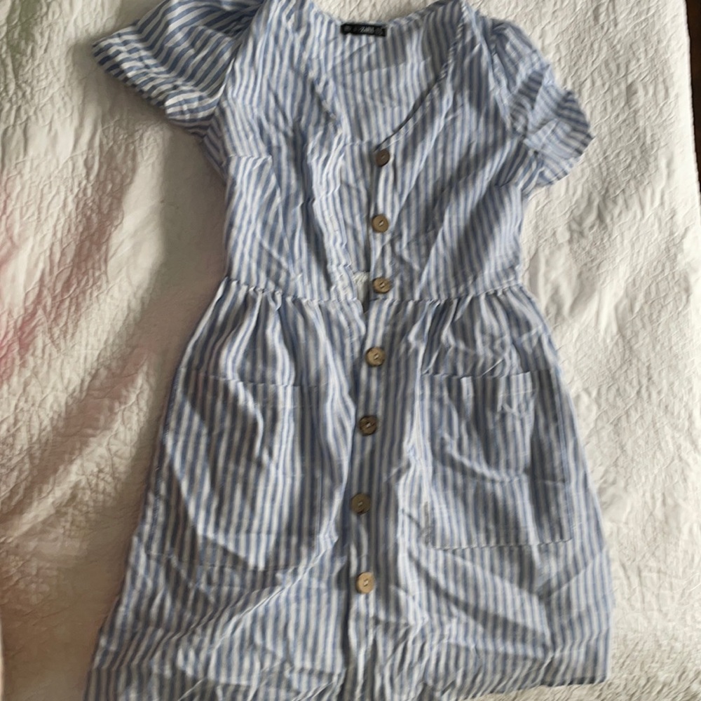 Dress has buttons all the way and pockets